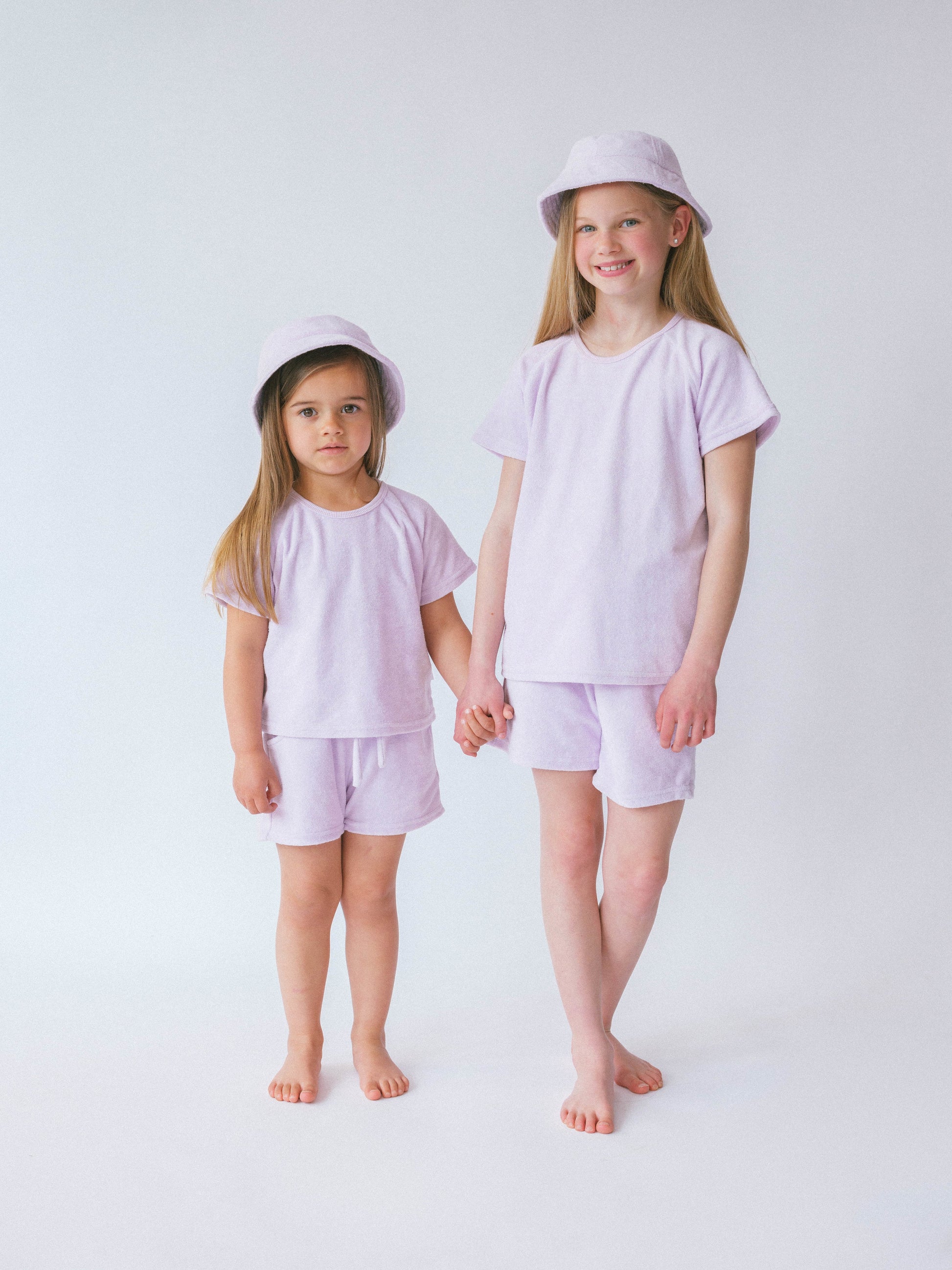 Close-up of the DreamBuy luxurious lavender towelling t-shirt, highlighting the super soft 100% cotton fabric ideal for kids' summer wear.