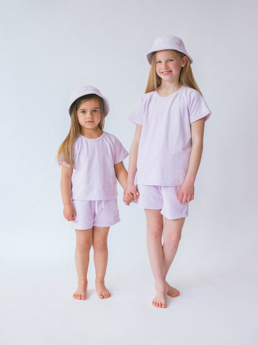 Close-up of the DreamBuy luxurious lavender towelling t-shirt, highlighting the super soft 100% cotton fabric ideal for kids' summer wear.