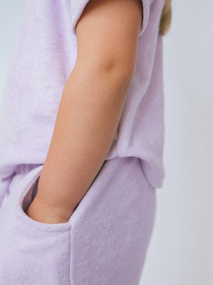 DreamBuy's 3-piece lavender summer outfit for kids, showcasing the stylish shorts with two pockets, perfect for summer adventures.