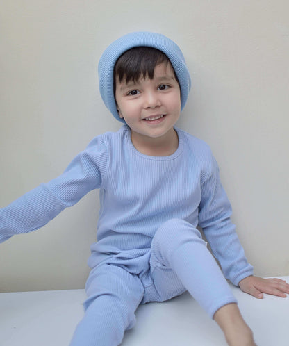 Family dressed in elegant Powder Blue Matching Pyjamas by DreamBuy, showcasing a chic minimalist design in soft cotton fabric, ideal for comfortable nights and stylish family gatherings.