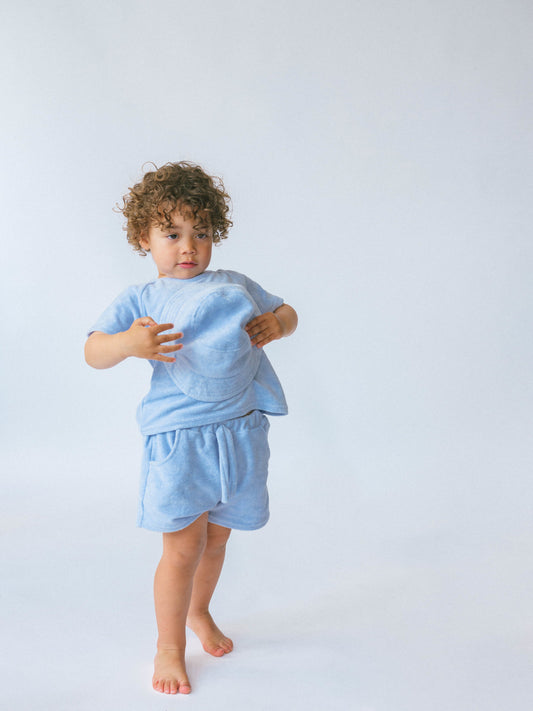 Luxury 3-piece coastal blue towelling set for kids by DreamBuy, featuring a personalized T-shirt, shorts, and bucket hat, perfect for summer adventures.