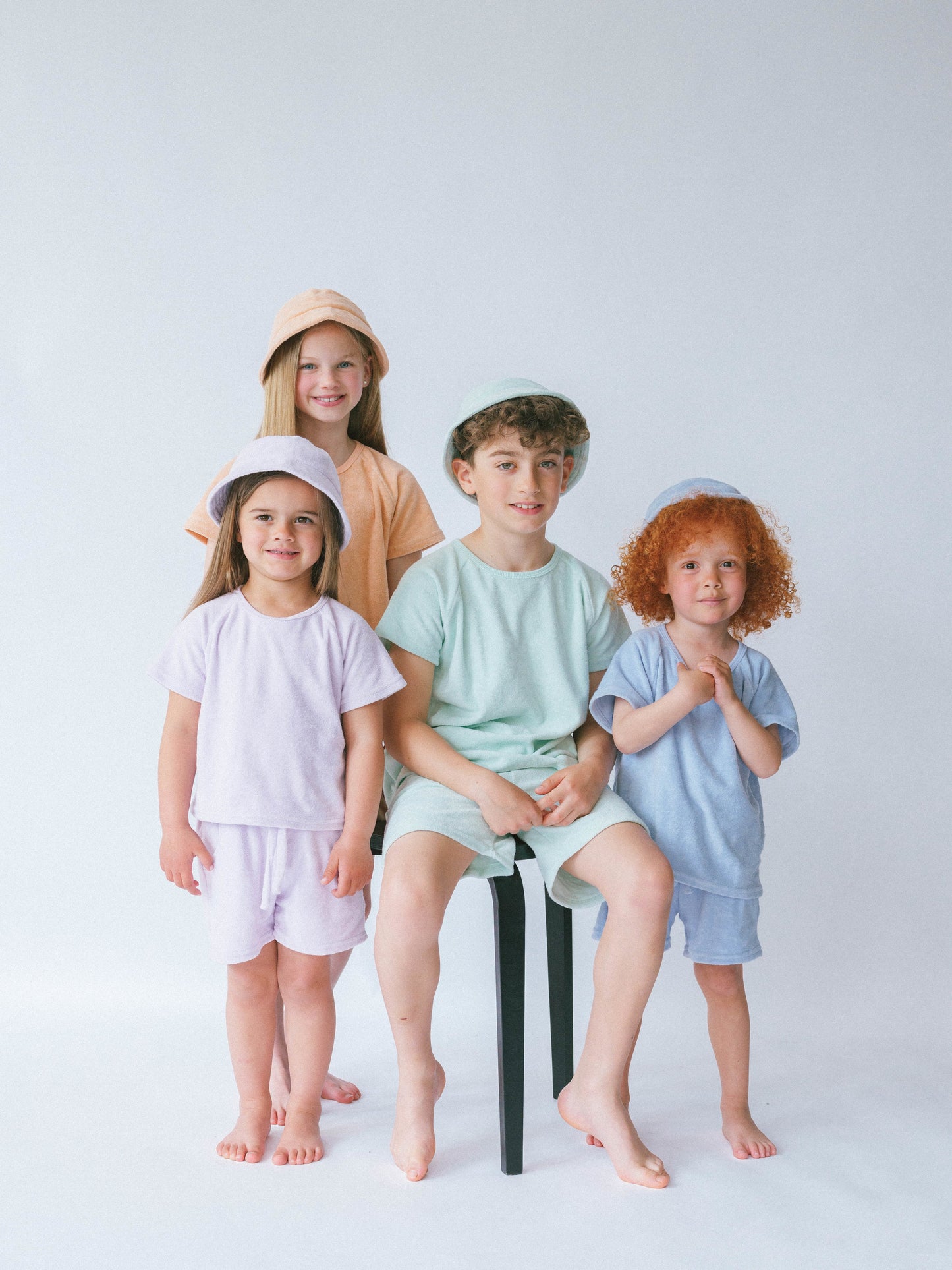 Personalized summer outfit for kids by DreamBuy, featuring a stylish top, shorts, and bucket hat in a vibrant coastal blue design.