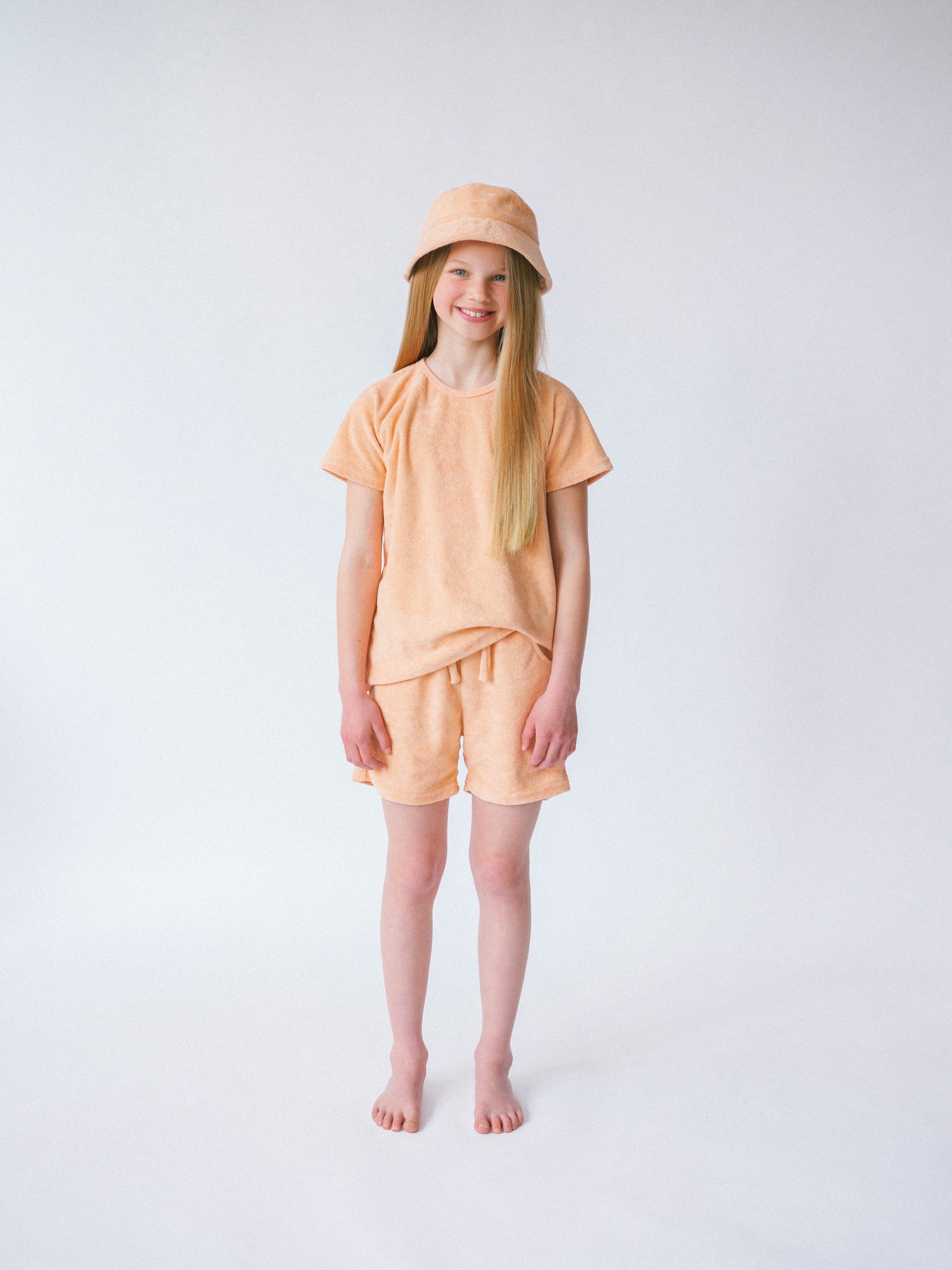 Stylish and comfortable children's summer outfit featuring a breathable top, shorts, and a fashionable bucket hat by DreamBuy.