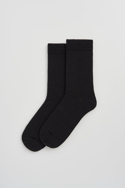 Stylish Merino wool calf-length socks in a sophisticated setting, highlighting their versatility and one-size-fits-most design.