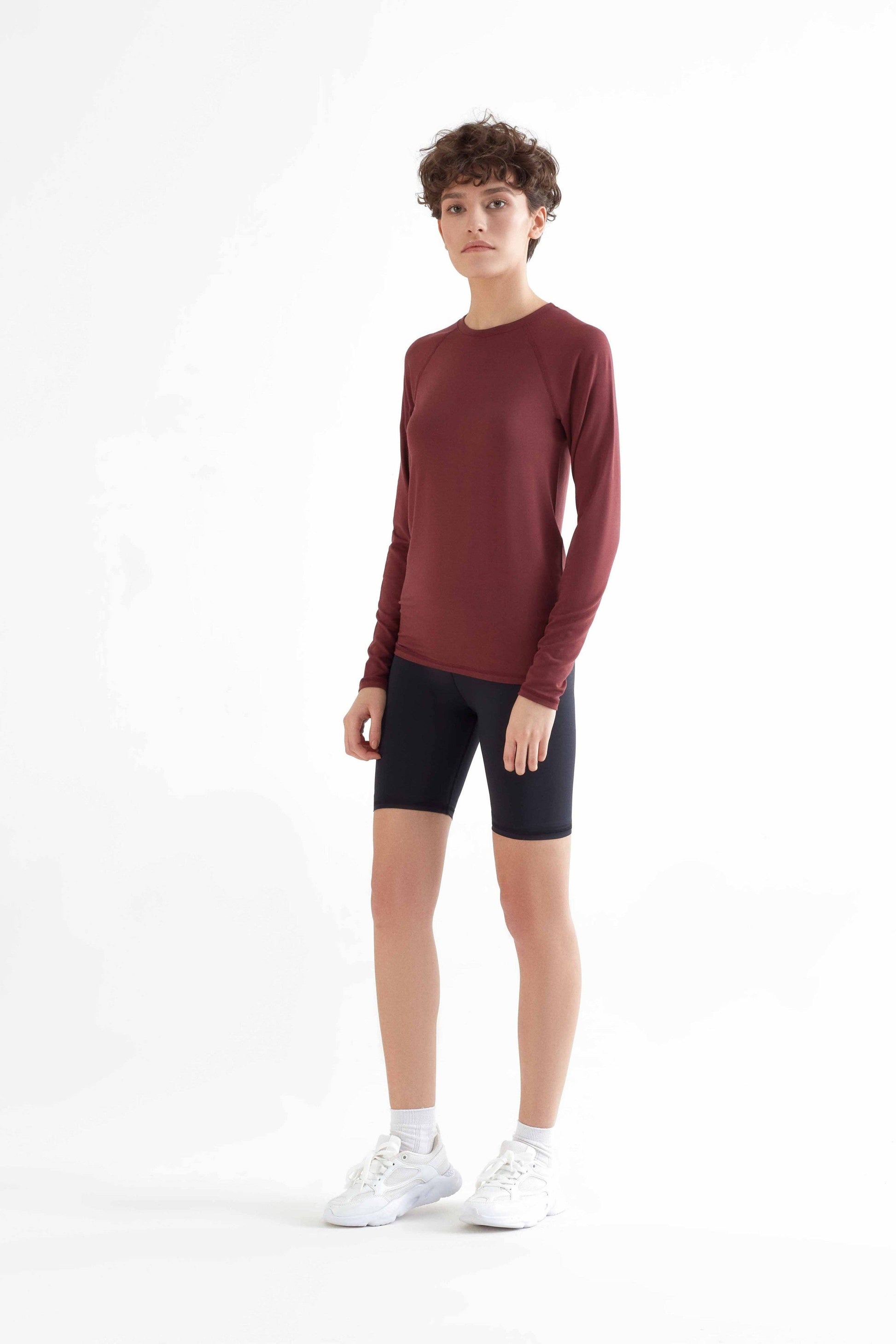 Elegant women's long sleeve Tencel shirt styled for versatility, transitioning seamlessly from workout to casual occasions with sophisticated minimalism.