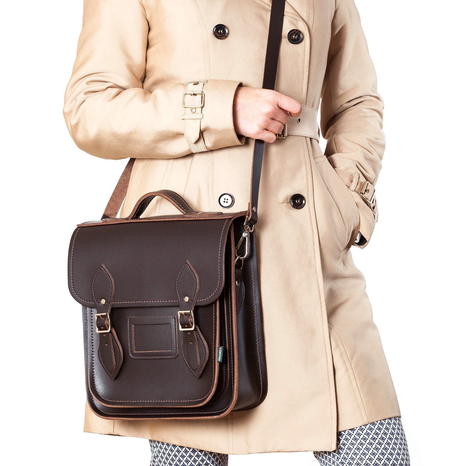 Customizable dark brown leather city backpack by Zatchels, adorned with traditional buckle fastenings and modern magnetic options for stylish convenience in daily essentials.