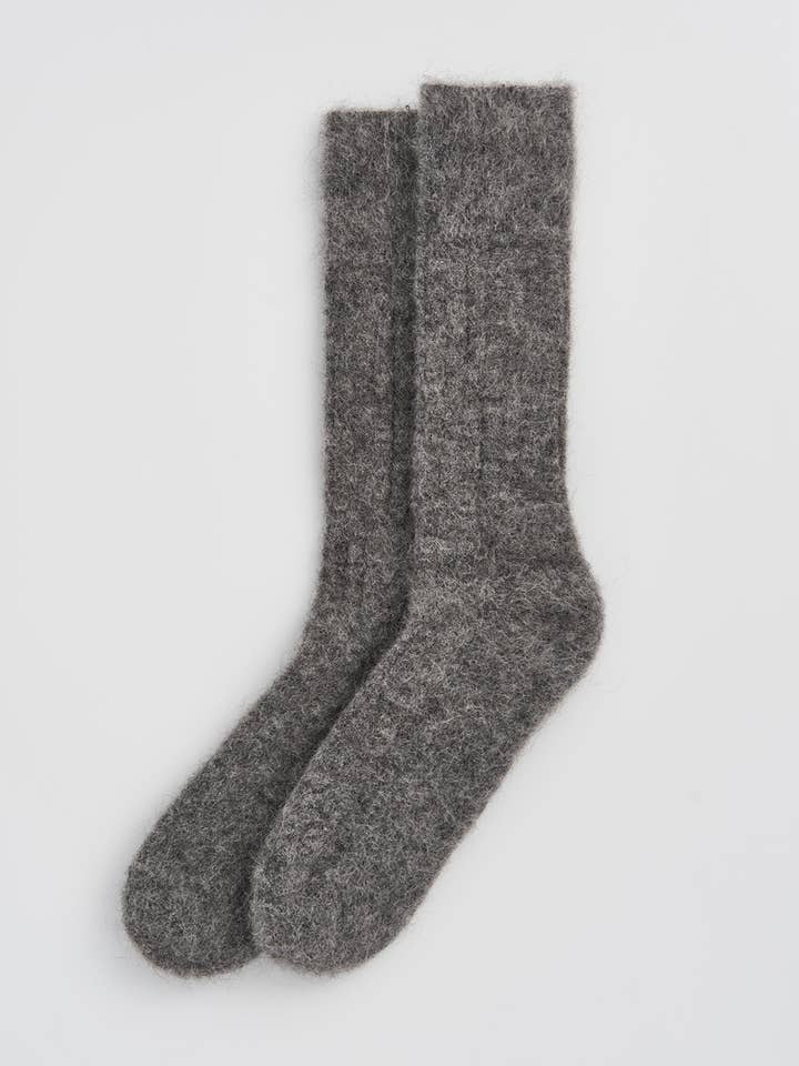Stylish presentation of one size fits most luxury bed socks made from 60% alpaca, perfect for warmth and indulgence.