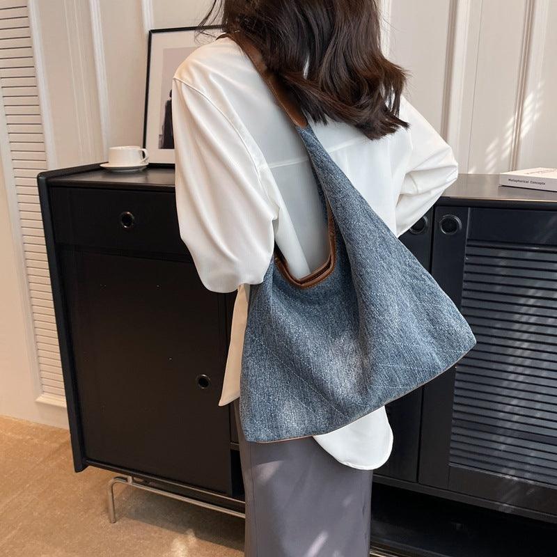 Luxury denim large shoulder handbag in dark blue, perfect for casual and business use, showcasing a stylish underarm design.