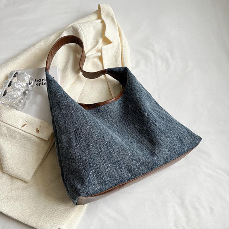 Stylish denim handbag with an adjustable shoulder strap, capturing the essence of luxury and versatility for various occasions.