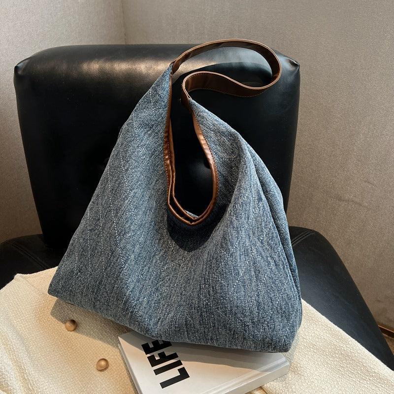 Luxury denim shoulder bag displayed with a fashionable outfit, embodying the perfect blend of style and practicality.
