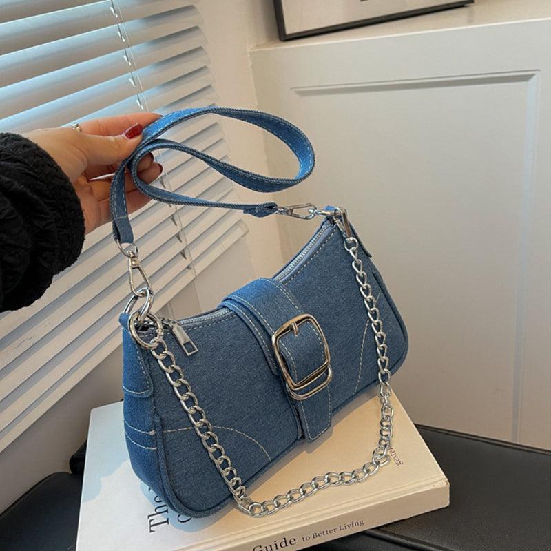 Sophisticated denim shoulder bag displayed with chic attire, exemplifying how to elevate your outfit with luxury accessories.