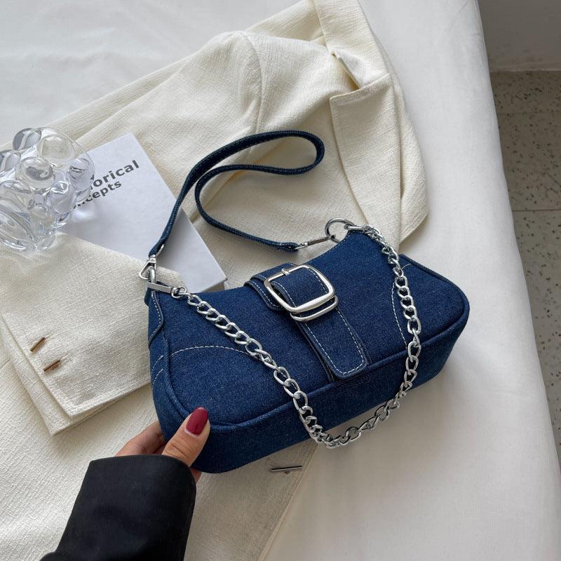 Stylish denim shoulder bag elegantly displayed, highlighting its modern shape and luxurious appeal.