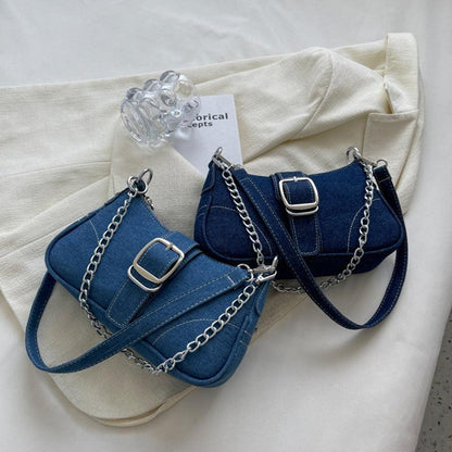 Elegant denim shoulder bag with luxurious chain strap, perfect for trendy women.