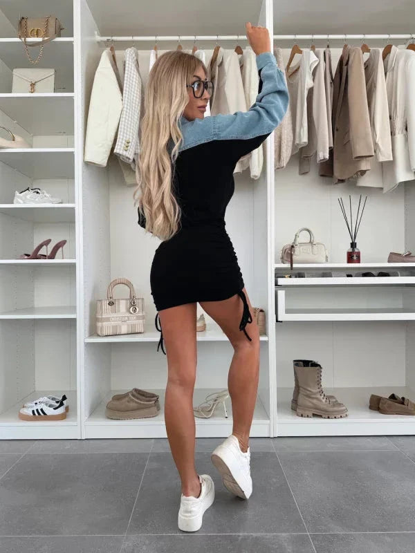 Model wearing an elegant denim and cotton dress, styled with boots for a trendy yet sophisticated look.