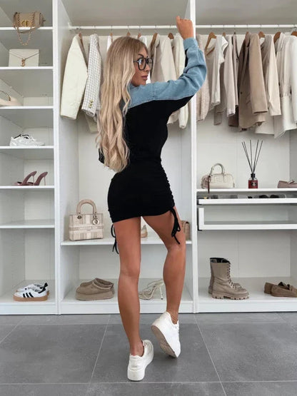 Model wearing an elegant denim and cotton dress, styled with boots for a trendy yet sophisticated look.