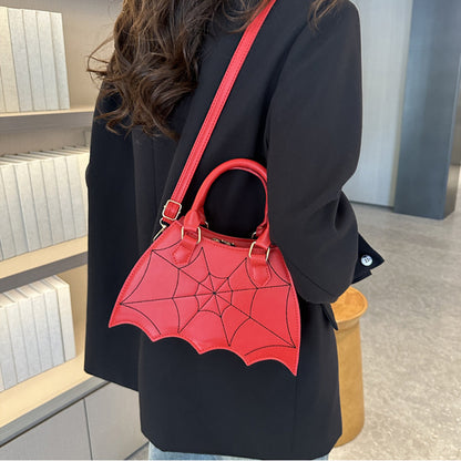 Bold red Halloween Spider Web Saddle Bag elegantly carried, featuring intricate spider web patterns, a luxurious accessory to enhance any festive outfit.
