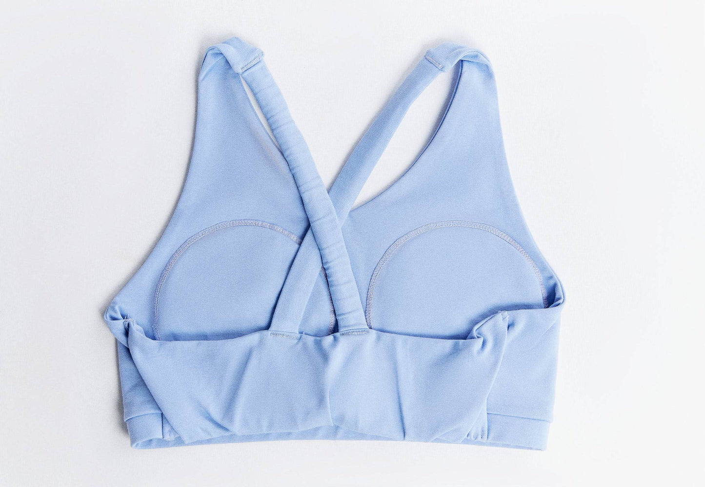 V-neck padded sports bra displayed in a stylish setting, emphasising its sustainable materials and chic design for modern women.