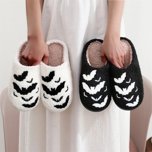 Funny Bat Slipper Halloween Pumpkin Flat Indoor House Shoes for Women Men, showcased in black and white versions, highlighting their plush design ideal for cozy Halloween festivities.