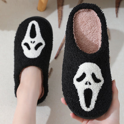 Chic Halloween Skull Cartoon Print Slippers held delicately, emphasising the unique skull motif and premium materials, an ideal winter-gifting choice.