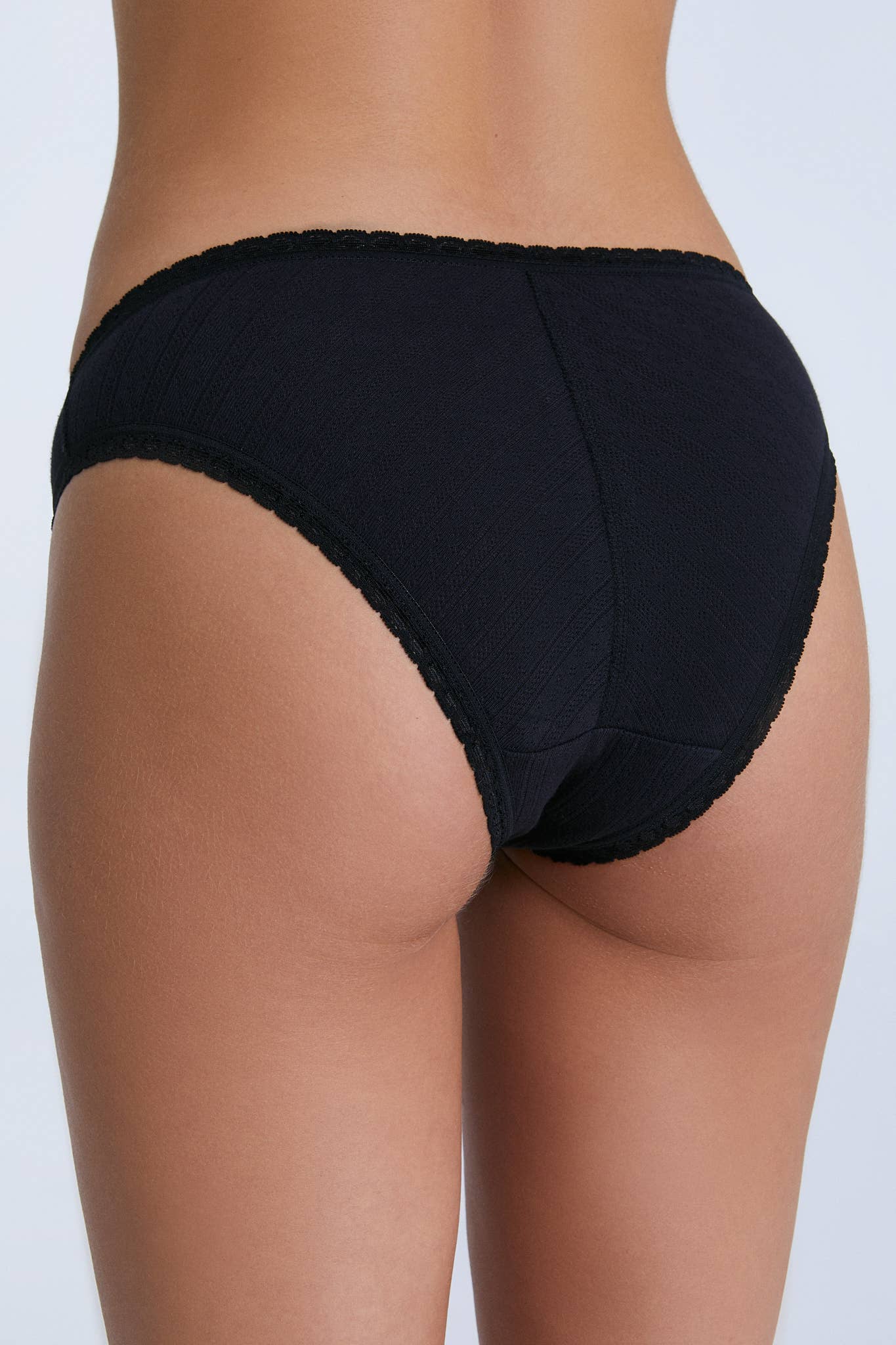 Elegant organic cotton jacquard slip dress with lace trim, depicting a classic feminine fit for women.