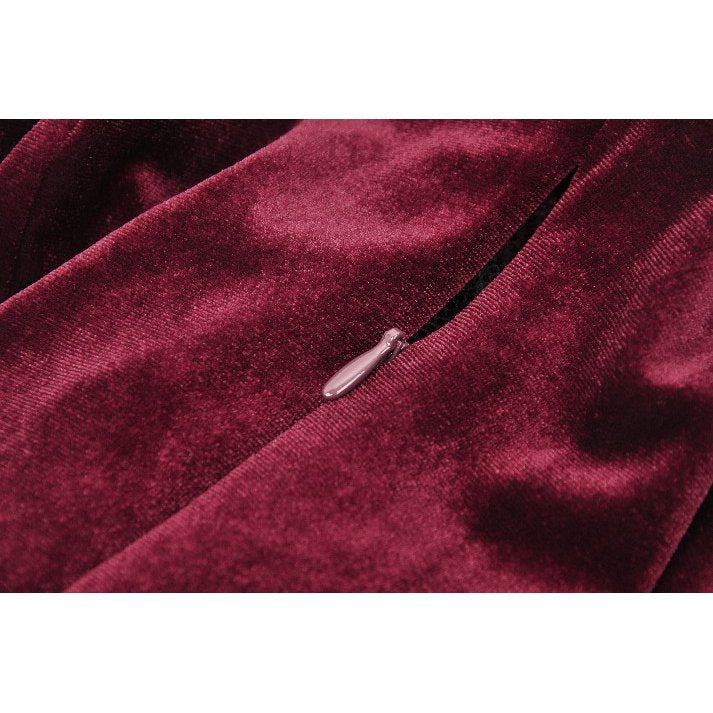 Stylish burgundy velvet dress with luxurious fabric and gothic lace accents, captured in a flattering angle to highlight its beauty.
