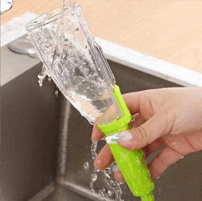 Elegant multifunctional stainless storage peeler in vibrant green with water flowing over it, showcasing its easy cleaning feature.