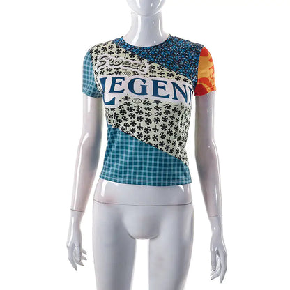 Flat lay of Sweet Legend Women's Vibrant Print Cropped Tee by Dazzling Dreams Studio, paired with accessories for an elegant outfit.