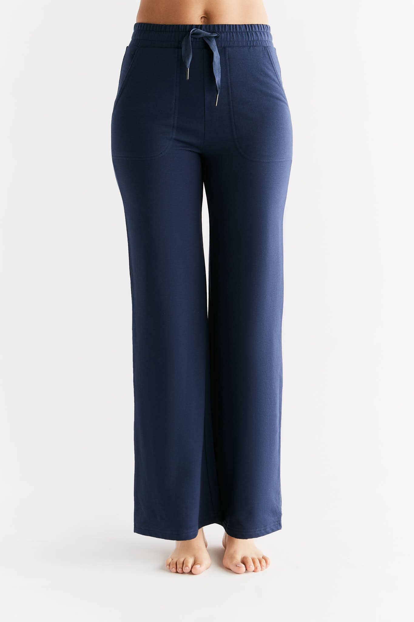 Luxury eco-friendly Tencel women's sweatpants displayed on a chic wooden background, emphasizing the blend of fashion and sustainability.