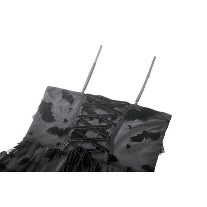 Stylish model showcasing the ruffled skirt and cut-out panel design of the Morwenna Bat Mesh dress.