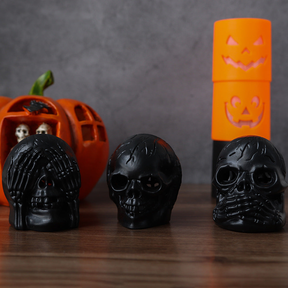 Halloween Skull Light Party Atmosphere Decoration - Showcasing a trio of black skull lamps displayed alongside a festive pumpkin, ideal for enhancing Halloween sophistication.