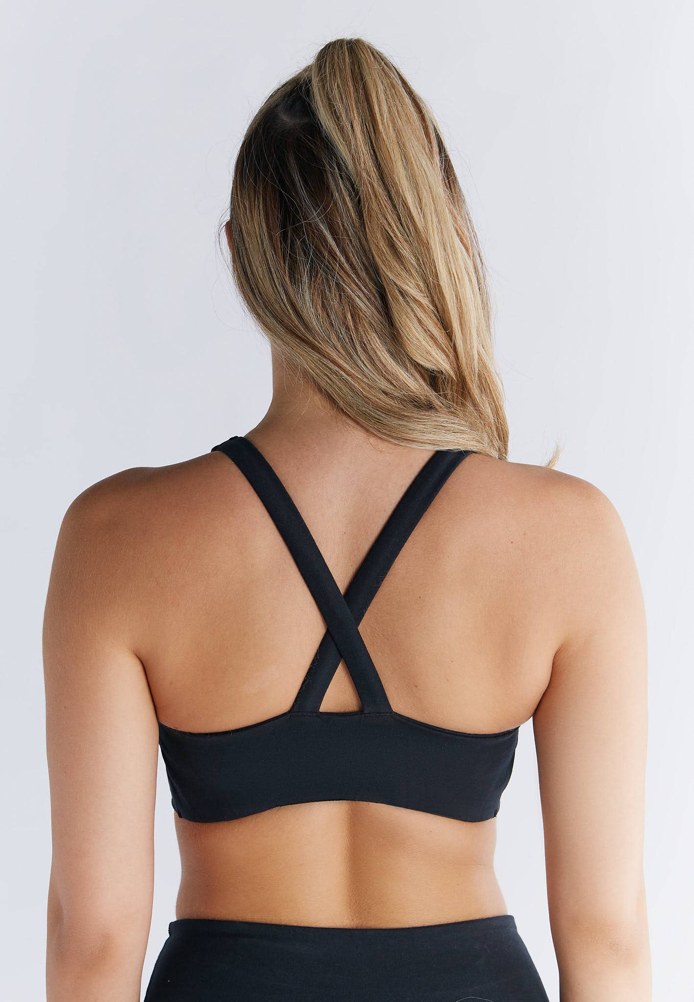 Luxurious organic cotton V-neck padded sports bra for ultimate everyday comfort, featuring a sleek figure-hugging design by Earth Wardrobe.