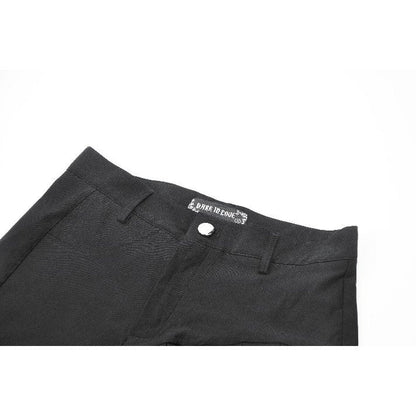 Detailed view of the Dark in Love Gwen pleated garter shorts showcasing the distinctive asymmetrical hem and detachable garter strap, epitomising punk-inspired elegance.