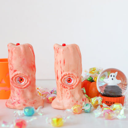 Halloween Blood Eye Lamp LED Electronic Light-emitting Candle Light surrounded by Halloween treats, featuring two luxurious candles with ghastly blood-streaked designs, ideal for upscale Halloween celebrations.