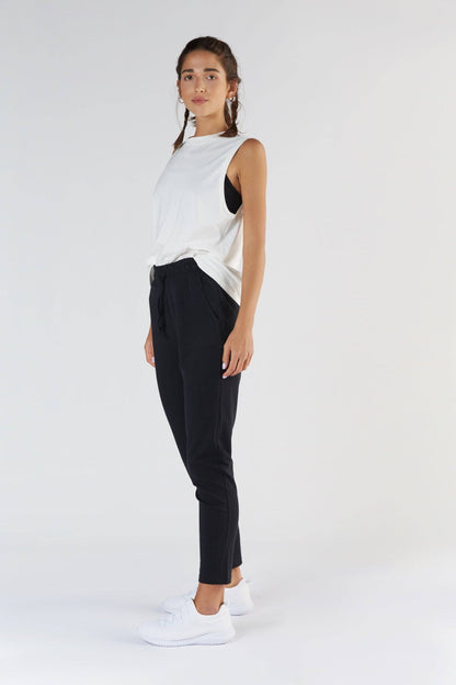 Model wearing relaxed fit women's sweatpants in a serene setting, representing comfort and luxury in everyday wear.