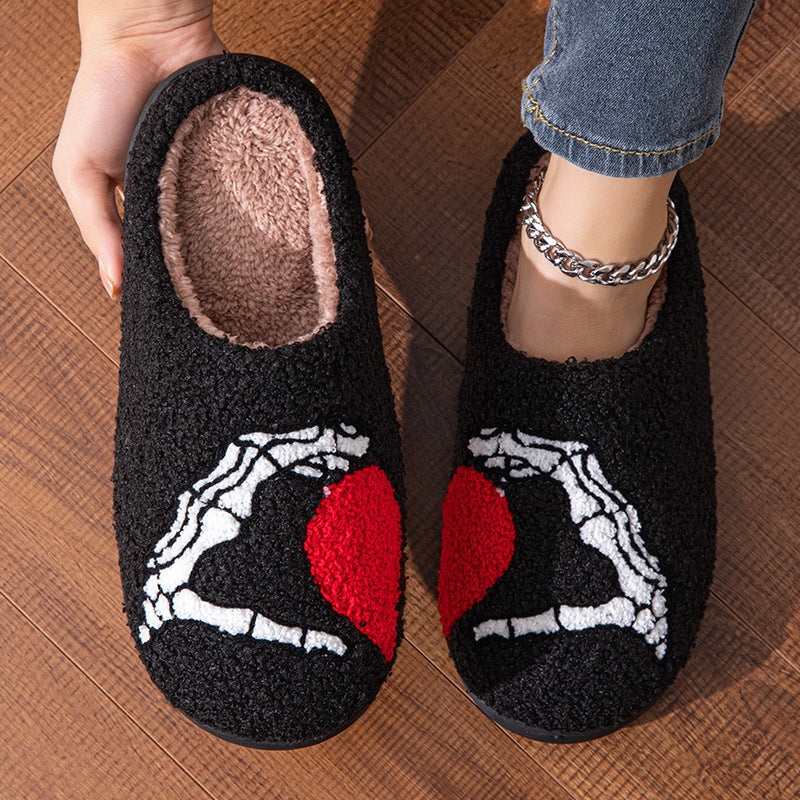 Funny Halloween Love Skull-hand Slippers showcasing a whimsical skull-hand design with a heart, crafted from luxurious materials for ultimate comfort. Ideal for both men and women, these non-slip soft-bottom slippers are perfect for winter relaxation.
