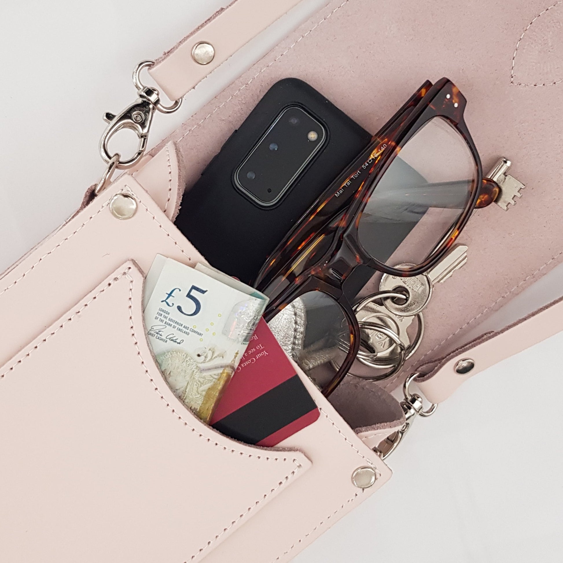 Detailed view of the magnetic closure and stylish buckle of the Handmade Cherry Blossom Leather Festival Phone Bag, highlighting exquisite design and craftsmanship.