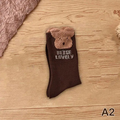 Luxurious brown socks with a cute bear face and 'BEAR LOVELY' text, a perfect blend of playful charm and sumptuous comfort.