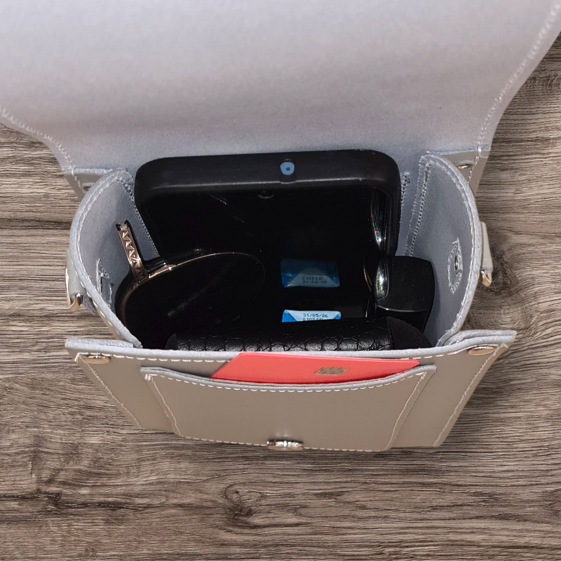 Close-up of the luxurious ghost grey leather festival phone bag, highlighting its exquisite craftsmanship and modern elegance.