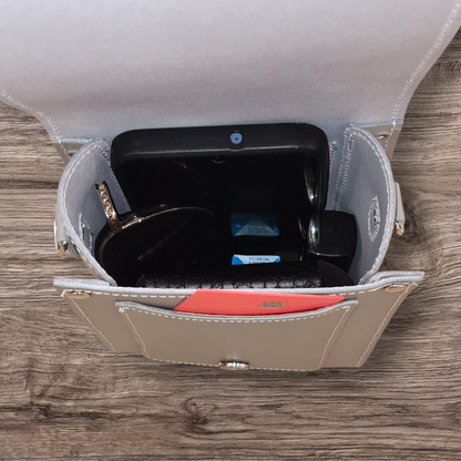 Close-up of the luxurious ghost grey leather festival phone bag, highlighting its exquisite craftsmanship and modern elegance.