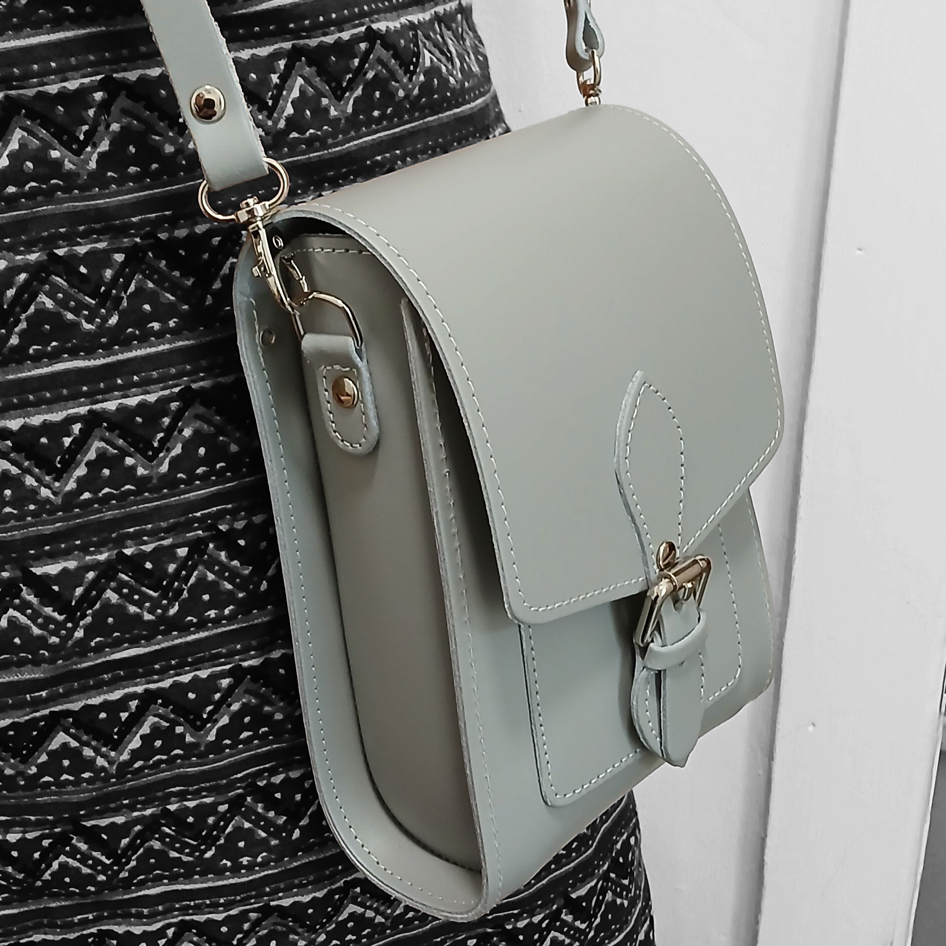 Inside view of the ghost grey leather festival phone bag, featuring spacious compartments and stylish magnetic closure.