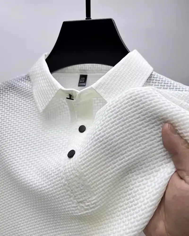 Luxurious white short-sleeved men's polo shirt featuring a stylish textured fabric and modern lapel design, showcasing comfort and elegance.
