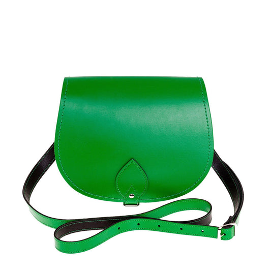 Handmade green leather saddle bag with adjustable crossbody strap and custom engraving option, showcasing premium craftsmanship and elegant design.