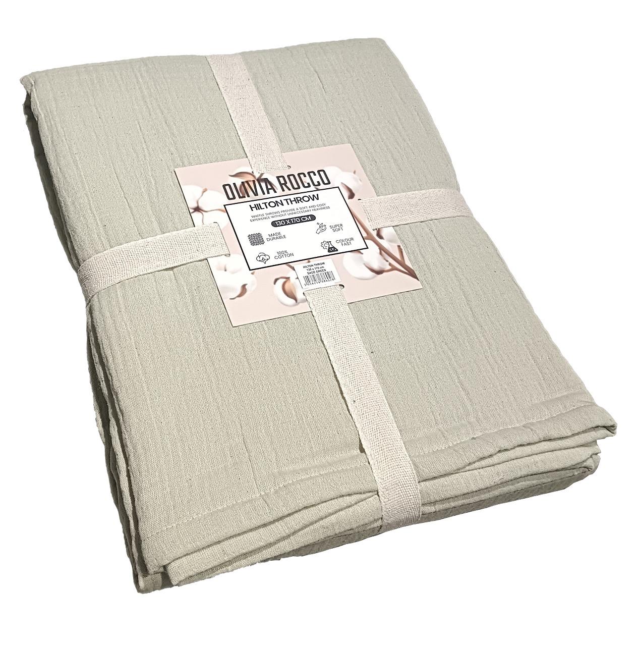 Hilton Reversible Throw Blanket in sage green and natural, showcasing luxurious soft cotton and intricate quilted design, perfect for enhancing contemporary home decor.