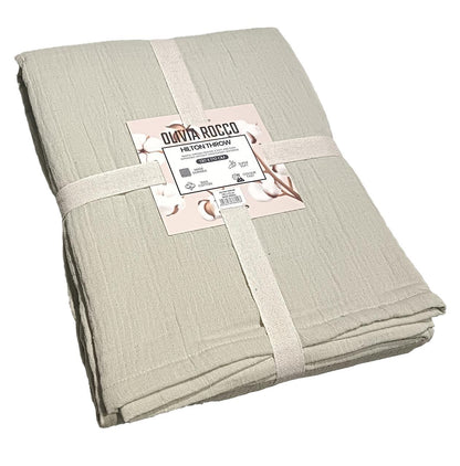 Hilton Reversible Throw Blanket in sage green and natural, showcasing luxurious soft cotton and intricate quilted design, perfect for enhancing contemporary home decor.