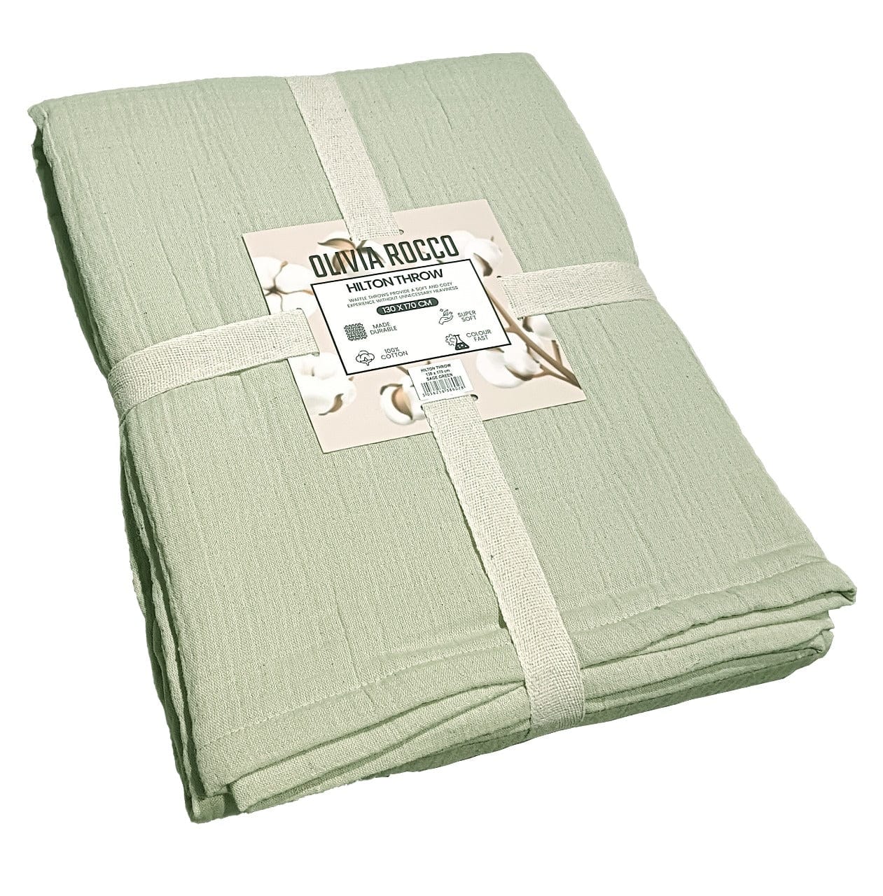 Full view of the Hilton Reversible Throw Blanket draped over a sofa, highlighting its elegant two-tone design in sage green and natural, epitomising comfort and sophistication.