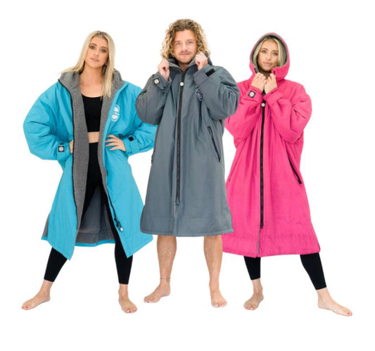 Luxurious waterproof unisex fleece changing robe by FatStick, perfect for beach and watersports, showcased in serene coastal setting.