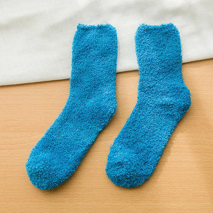 A pair of Luxury Women's Soft Fluffy Vibrant Socks by Dazzling Dreams Studio perfectly fitted on feet, ideal for both home and casual outings.