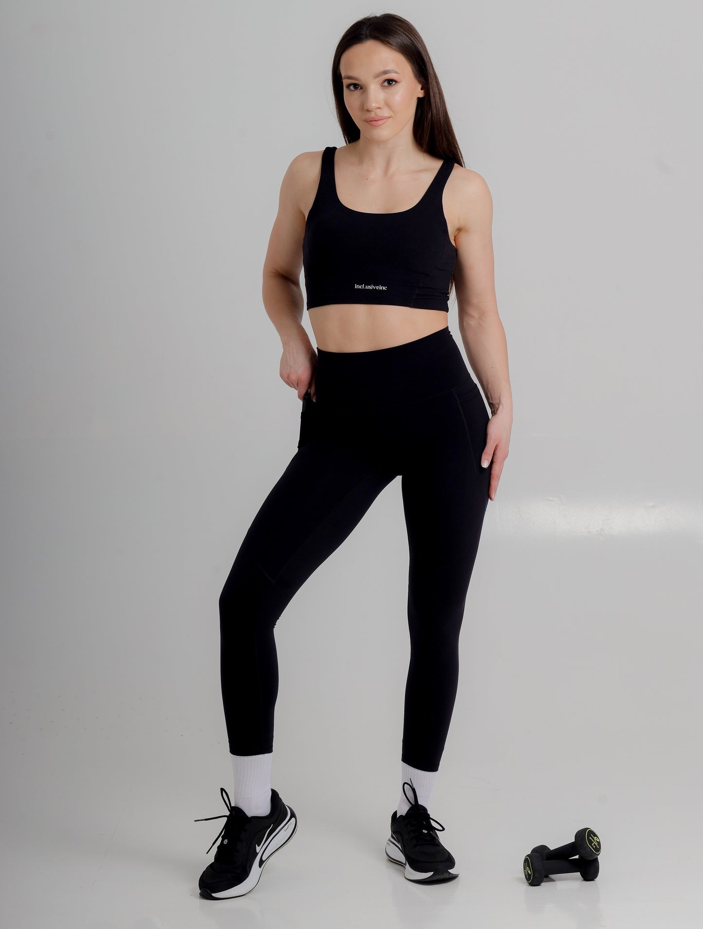 Luxurious black high-waist leggings with pockets from Incl.usiveinc, designed for performance and style, ideal for gym and casual wear.