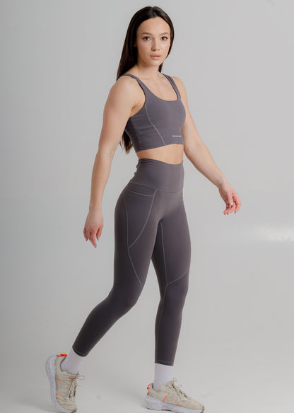 Sculpting leggings by Incl.usiveinc featuring functional side pockets, perfect for athletic high performance.