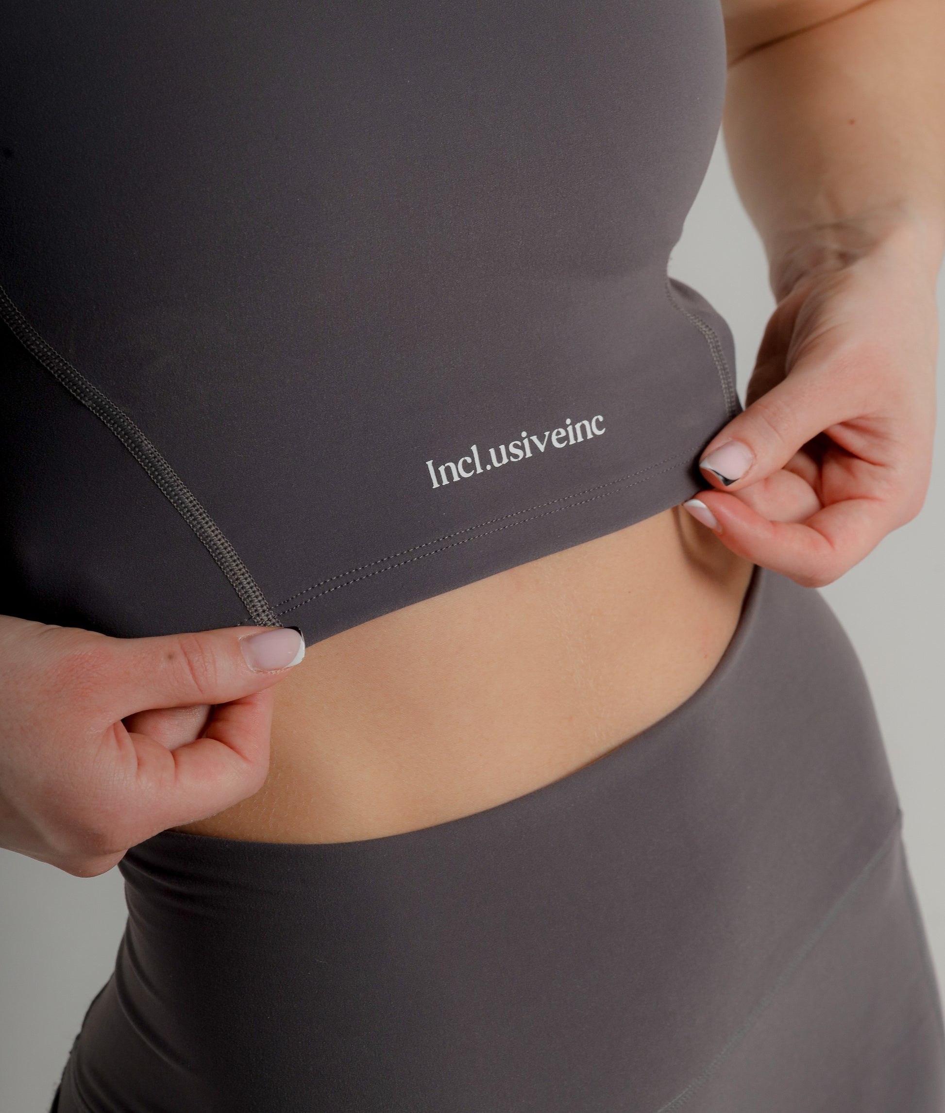 Stylish Active Grey Sports Bra by Incl.usiveinc, showcasing high support and sweat-wicking fabric, designed for luxury fitness enthusiasts.